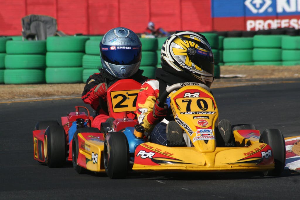 Two go-karts racing on a track showcasing competitive motorsport action.